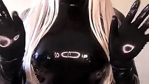 Living barbie doll in jet latex catsuit
